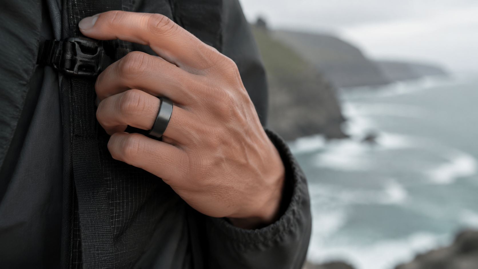 Matte black screenless HealthRing worn outdoors on a hike